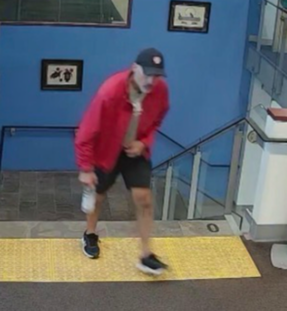 Kenneth Bosada in the October 14 image released by Halton Regional Police, wearing a red jacket and dark shorts